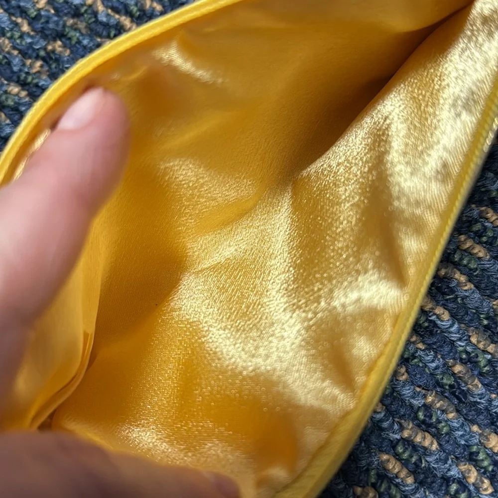 Small gold cosmetic bag w/decorative zipper pull. NWT